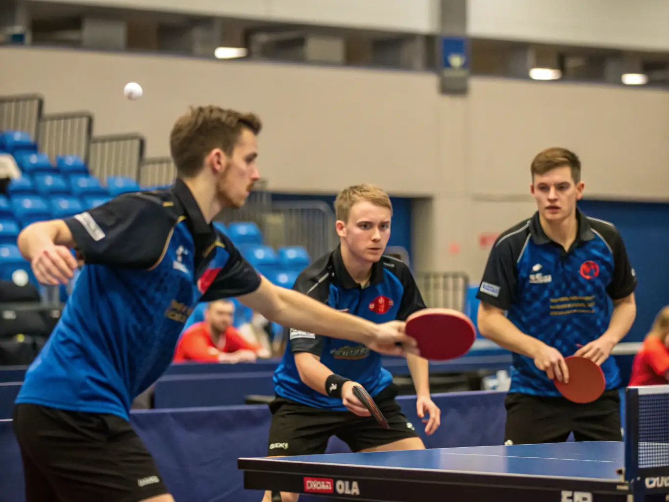An image showcasing adult members engaged in a competitive table tennis match, demonstrating focus and strategic gameplay in a well-equipped facility.